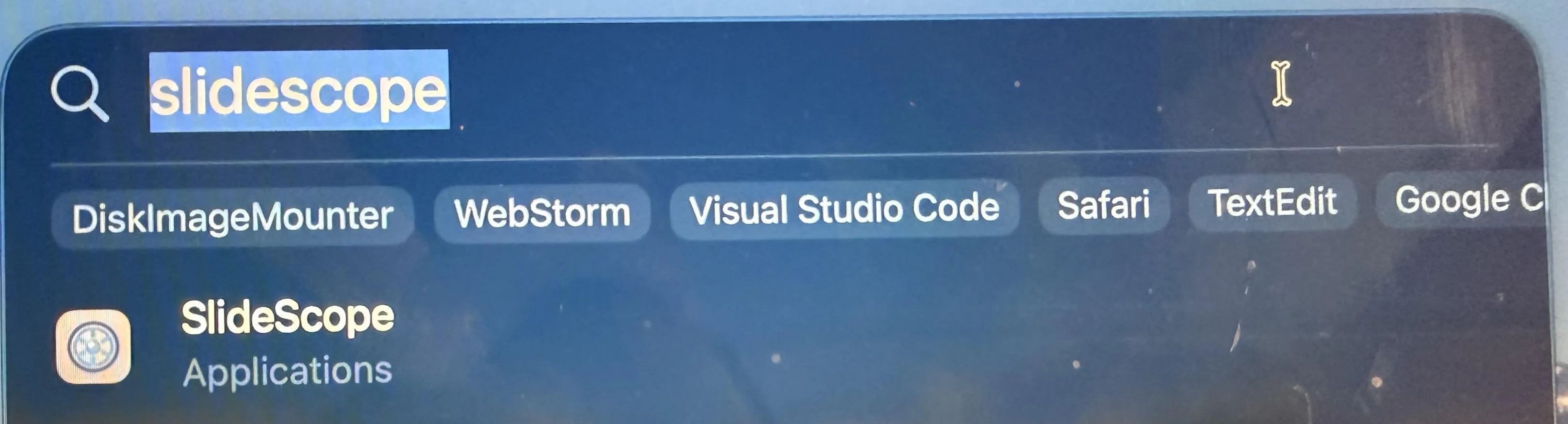 Spotlight search showing SlideScope in Applications.
